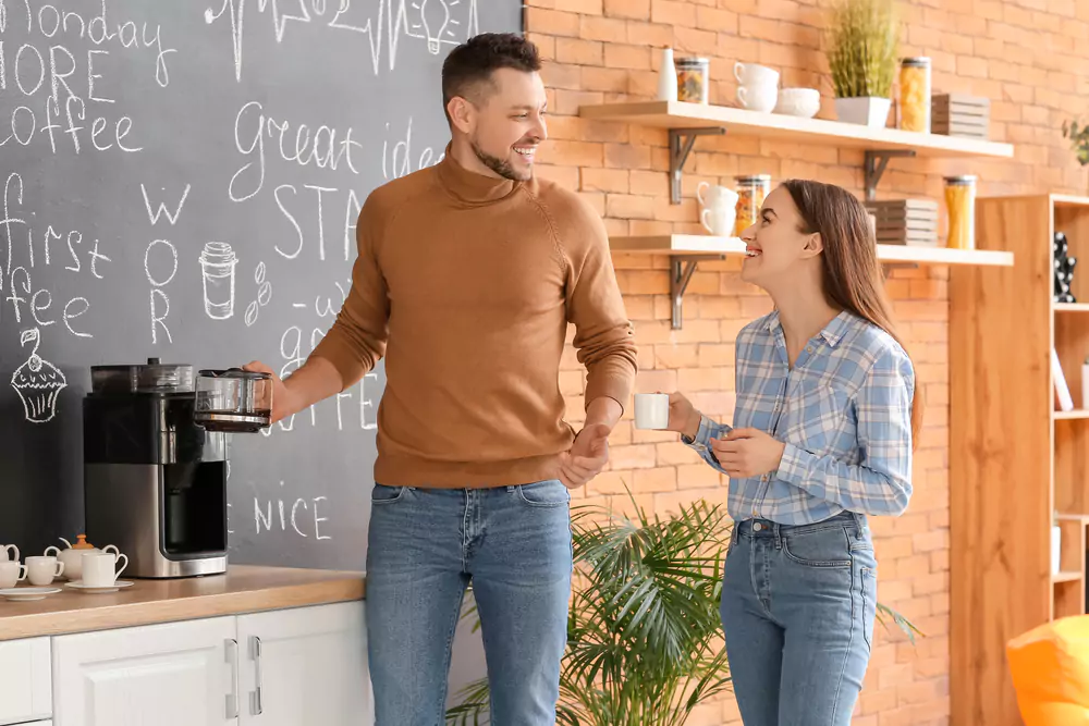 two coworkers at the office coffee machine