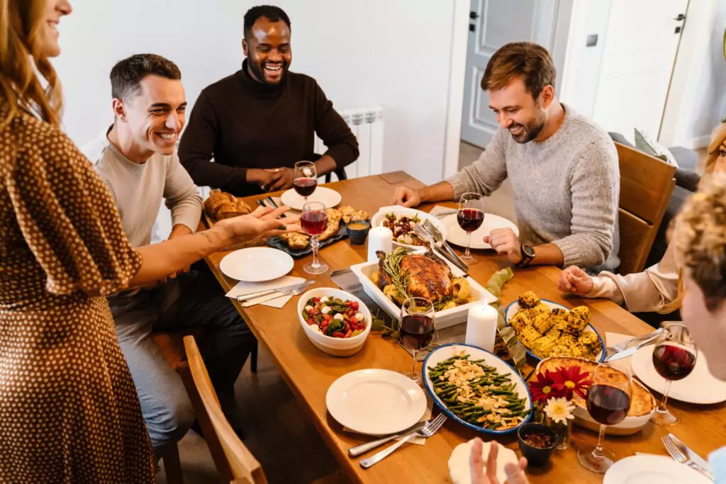 a group of people enjoying a Thanksgiving supper