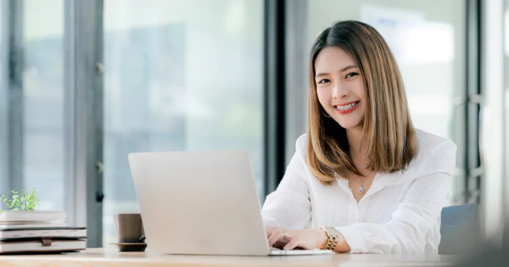 smiling woman using a laptop