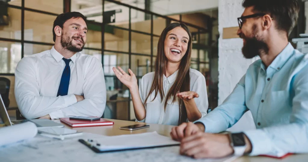 coworkers talking and smiling