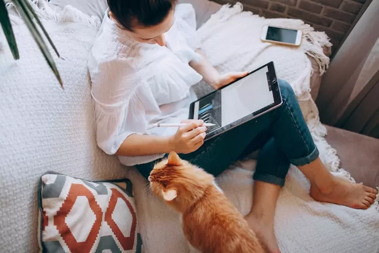 Woman working at home on a tablet