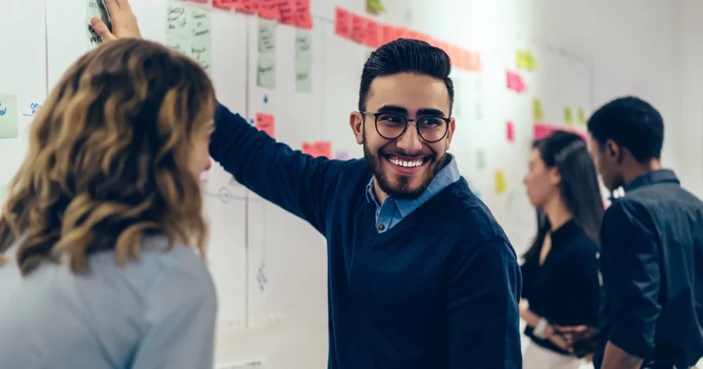 smiling man in sweater in an office setting