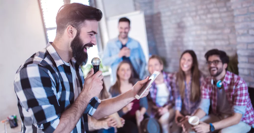 man doing a team building game with a microphone