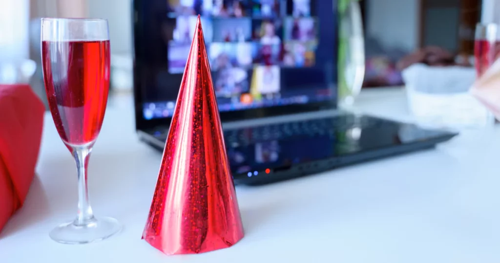 party hat and glass and computer