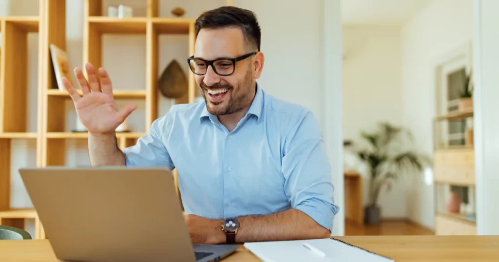 smiling man on computer