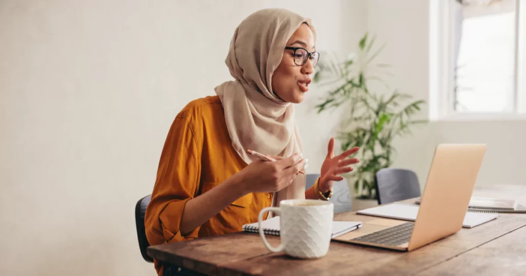 woman-glasses-headscarf-laptop-talking