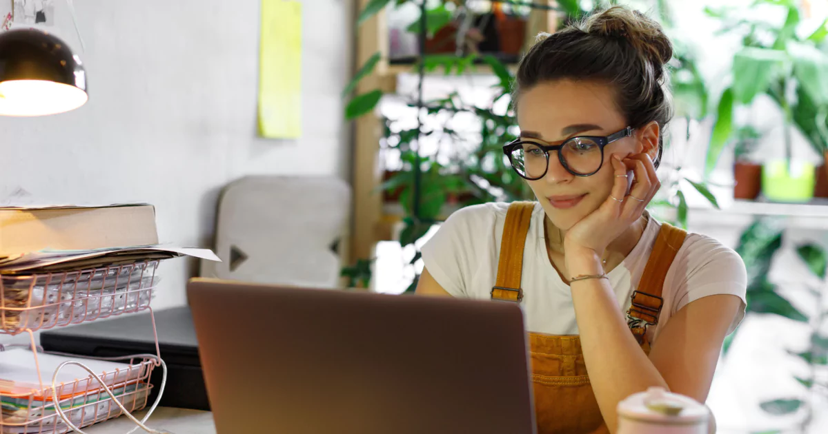 woman hair bun glasses laptop