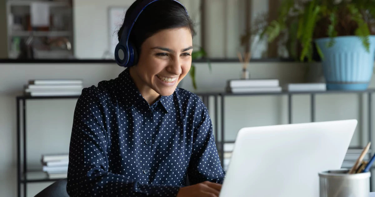 woman headphones smile laptop