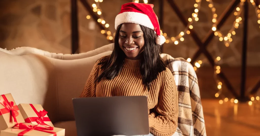 woman santa hat laptop lights