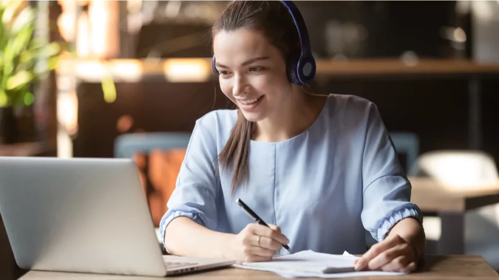 young-woman-brown-hair-headphones-blue-shirt