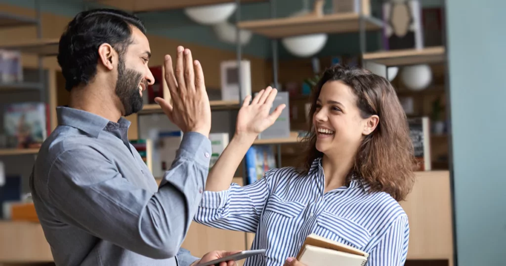 high-five-happy-coworkers-blue-shirts