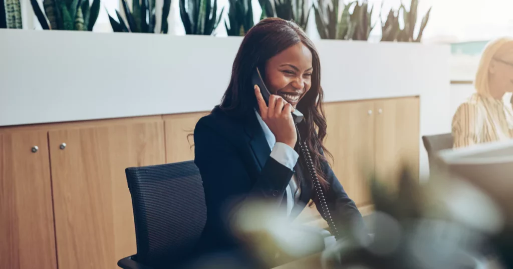 smiling-woman-blazer-office-phone