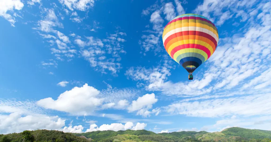 a hot air ballon over a field 