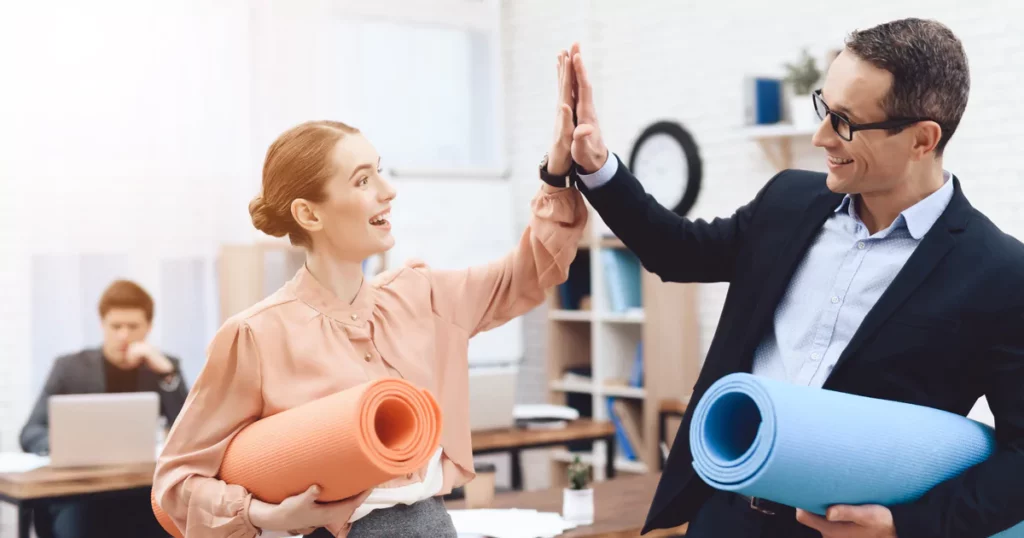 coworkers-high-five-yoga-mats.