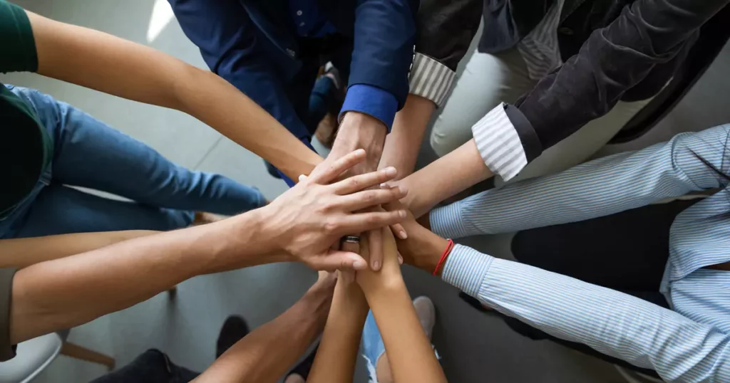 team-building-nashville-pile-of-hands-teamwork