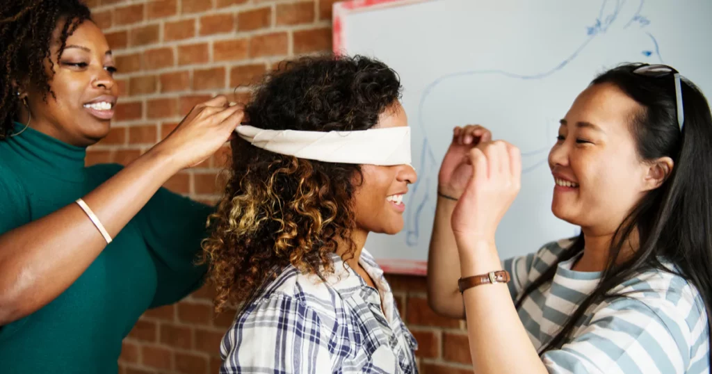 employees blindfolding each other