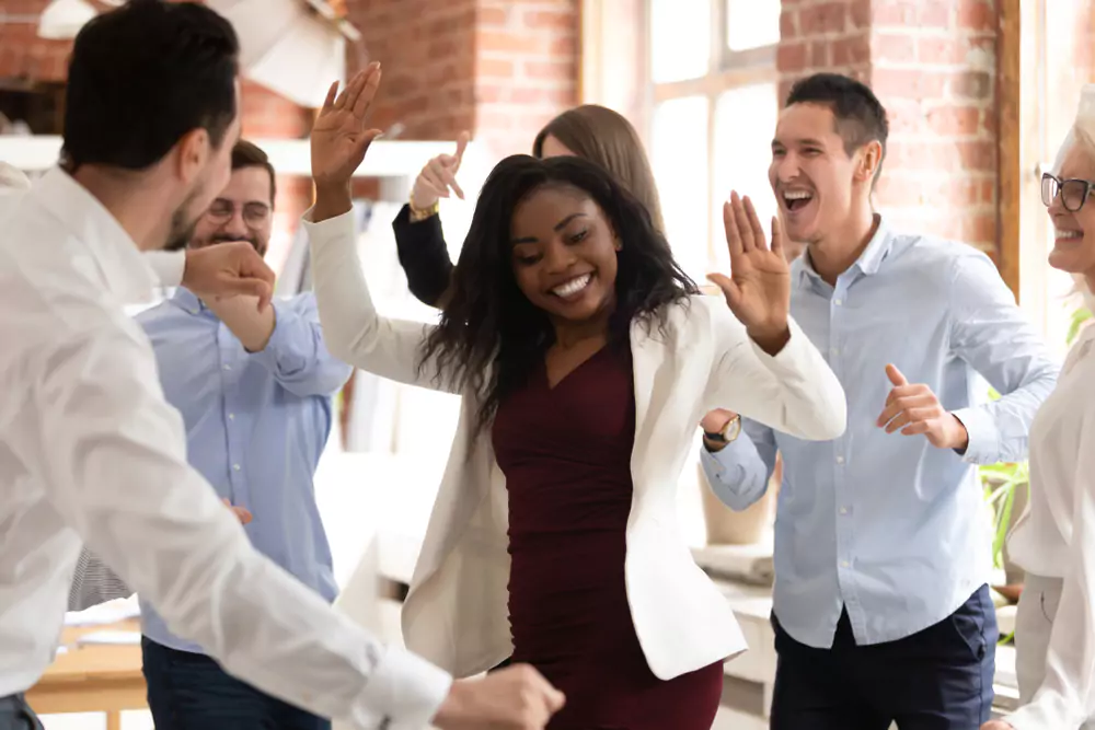 employees dancing in office