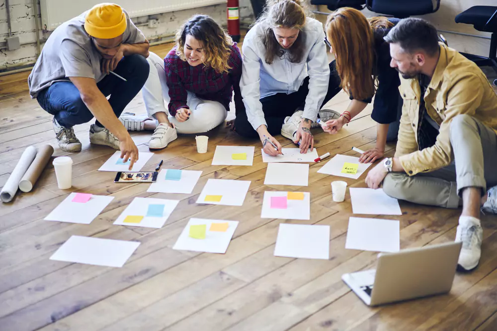 employees looking at paper on floor