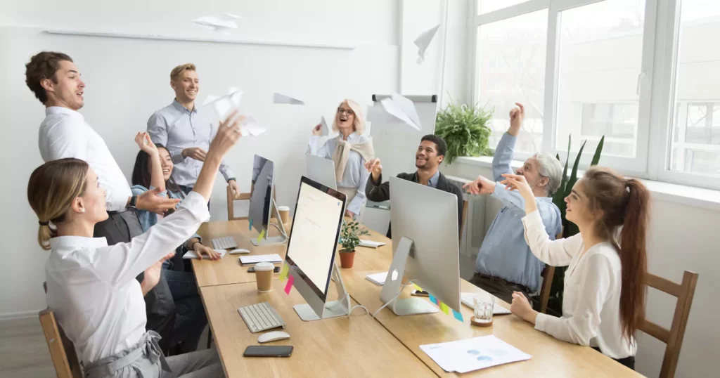 employees throwing paper planes