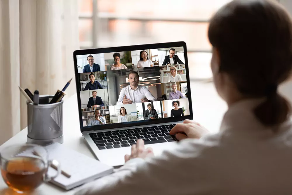 employee logging on to zoom call with others