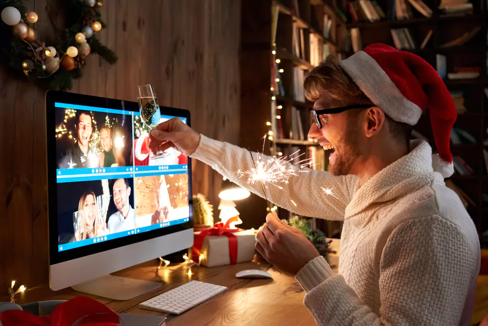 employee with santa hat at virtual holiday party