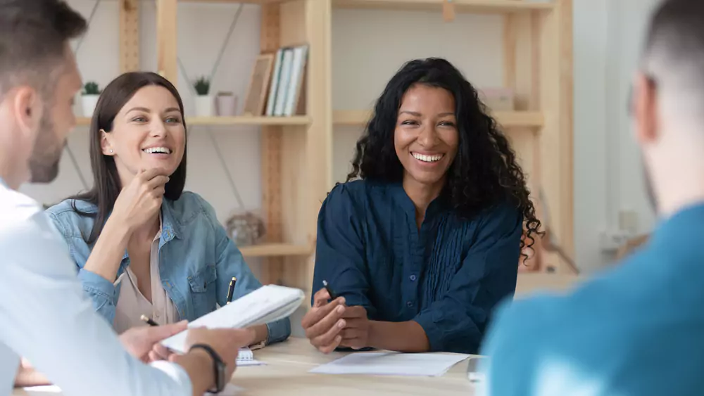 employees laughing in a circle