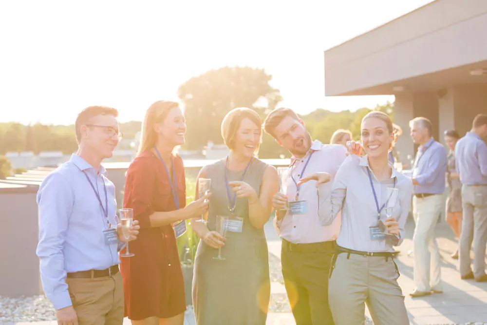 employees mingling after conference at bar