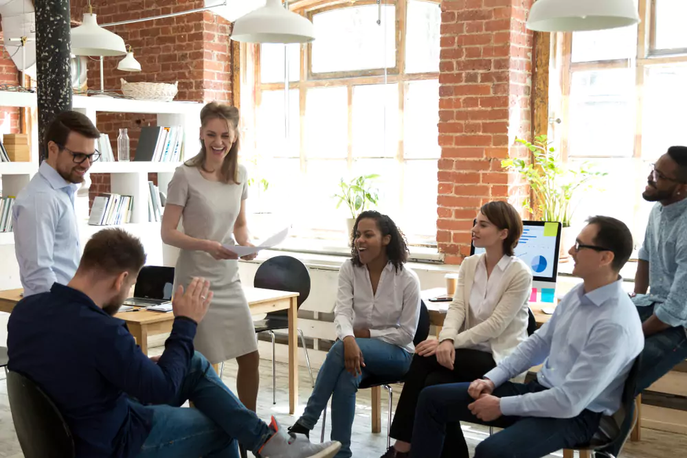 employees standing at fun meeting