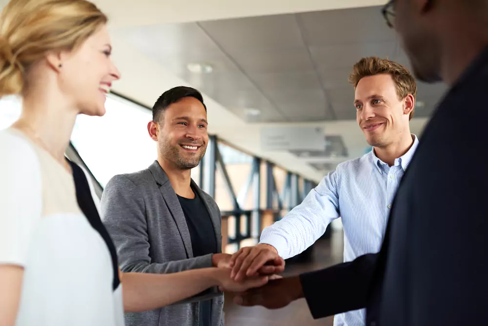 employees with hands in center