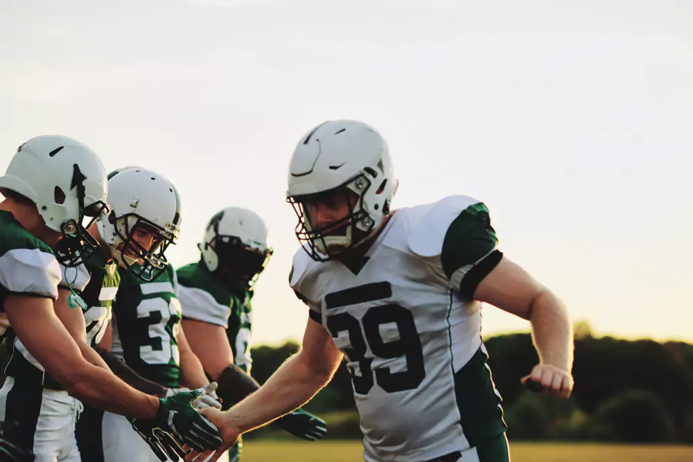 football players high fiving