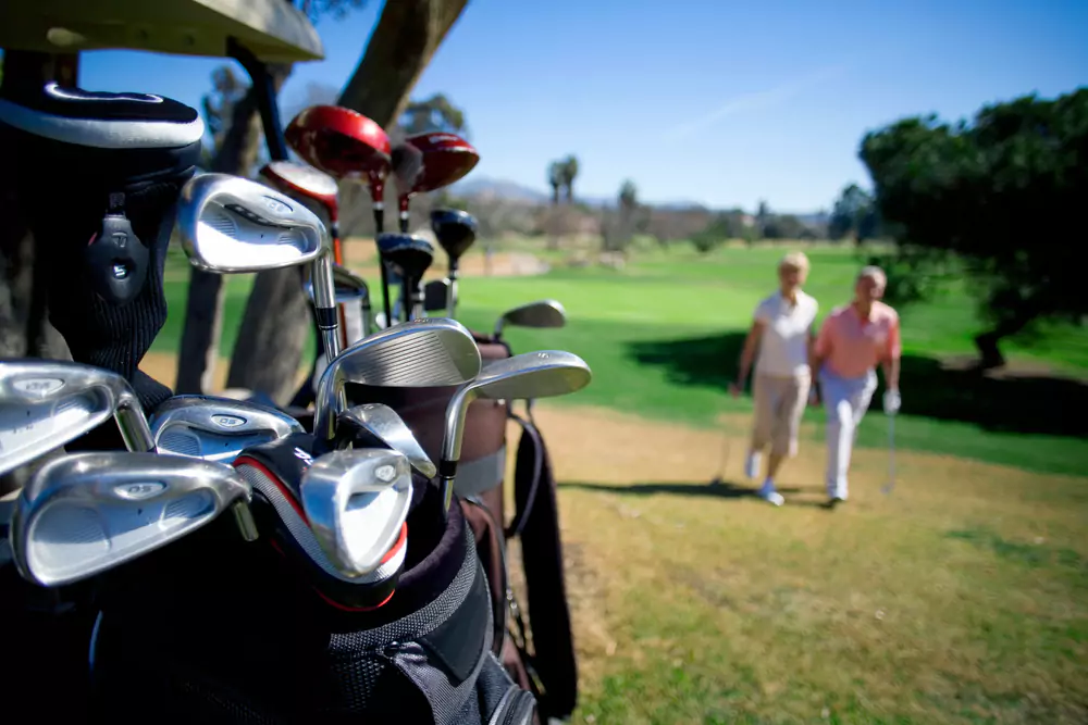 retired employee using golf clubs