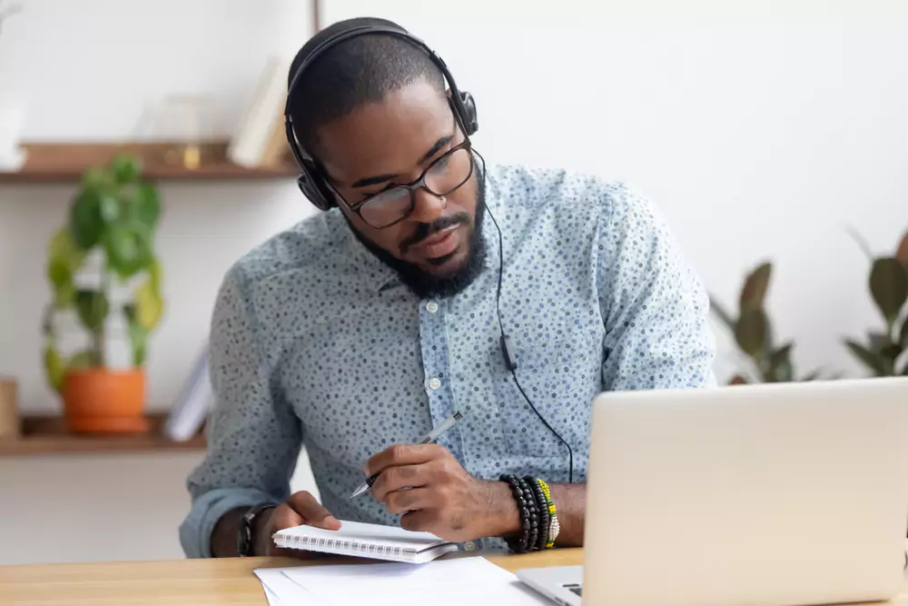 team member taking notes at a webinar