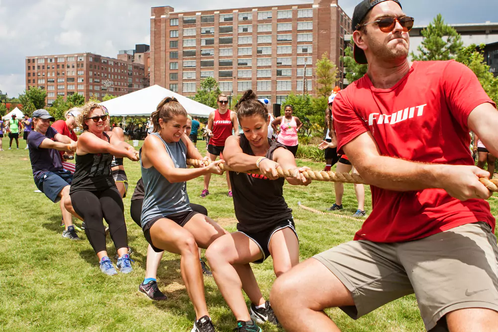 team members playing tug of war at team sports day