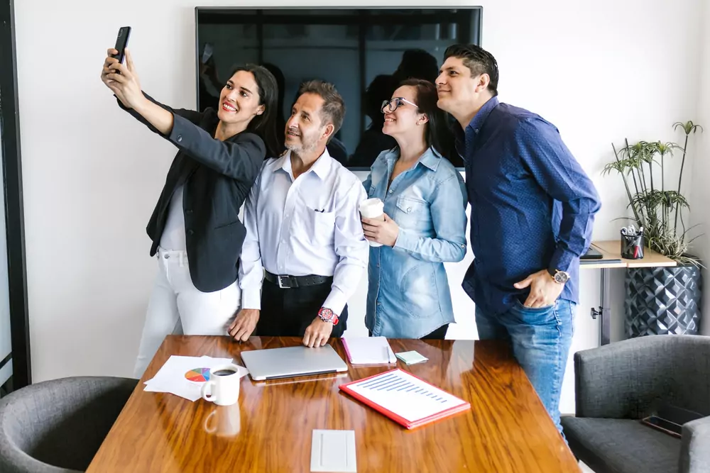 team member taking selfies with boss