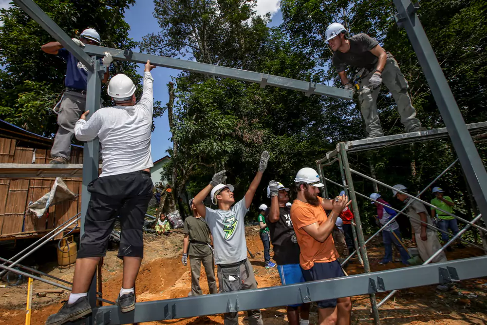 volunteers building a home