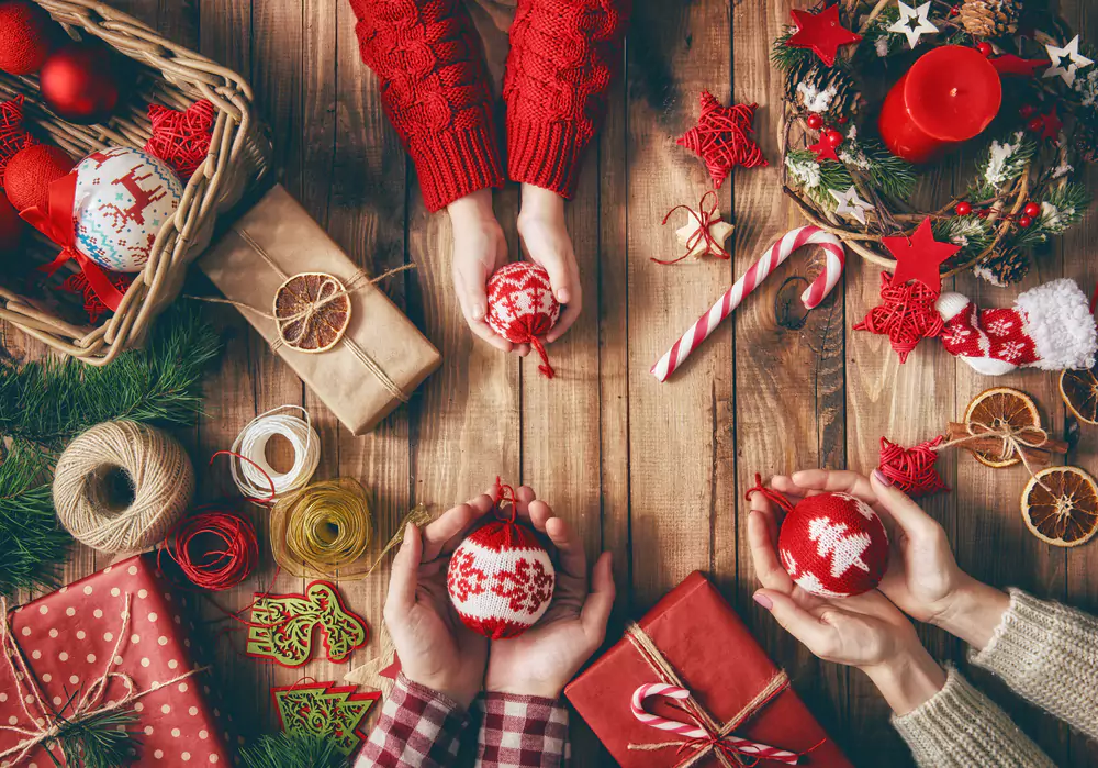 team members holding holiday decorations